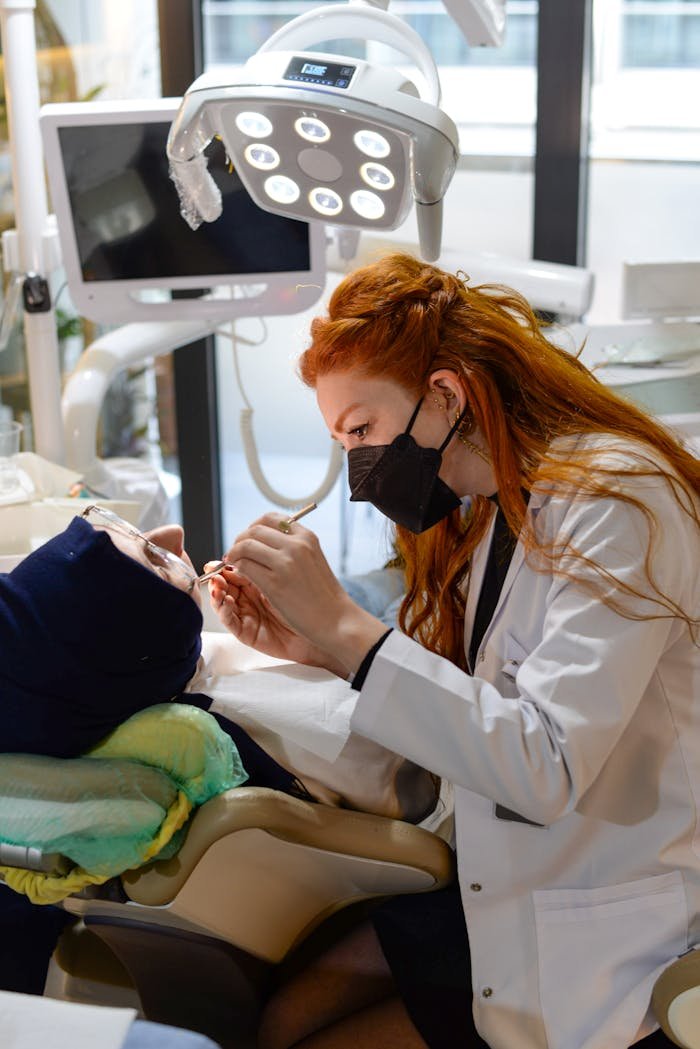 Professional female dentist working on a patient's teeth in a modern dental clinic.
